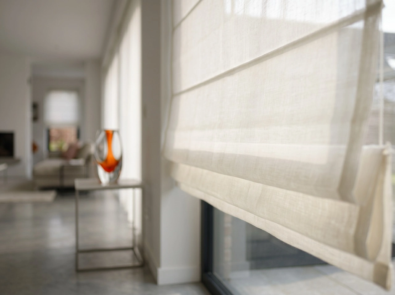 Roman Blinds 5 Cream sheer roman blinds Melbourne in a bright hallway with polished concrete floors and orange glass vase on side table