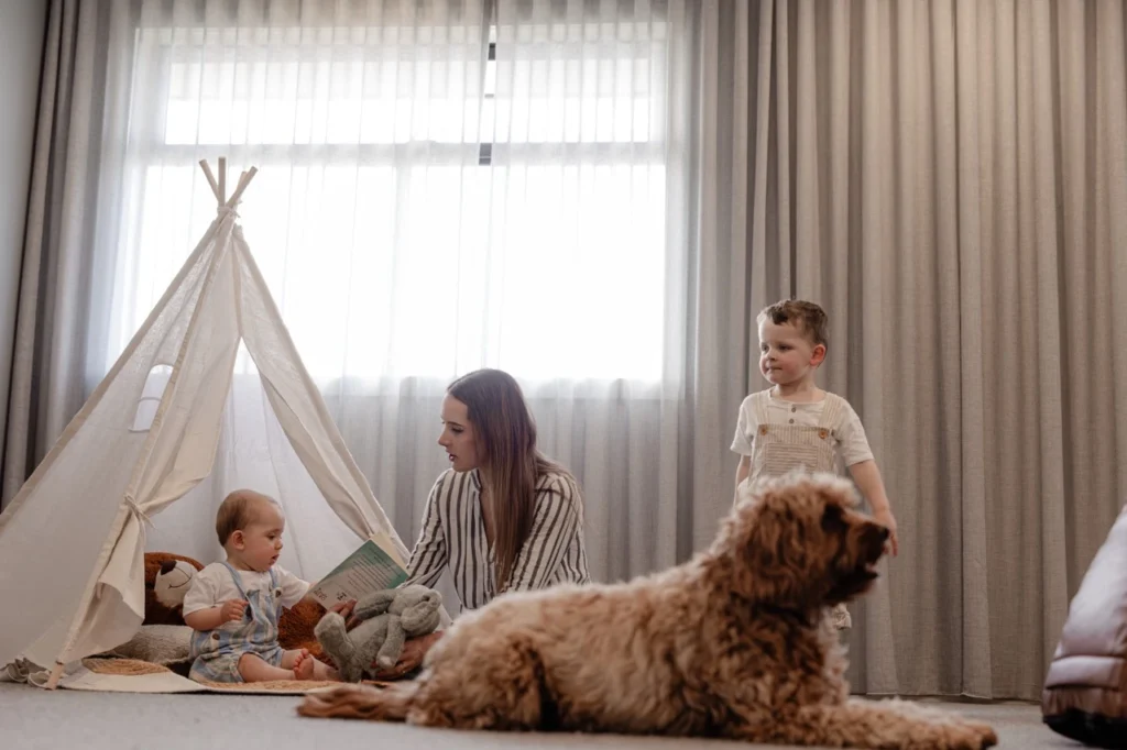 Custom Sheer Curtains in Modern Melbourne Living Room by IMEKO Blinds Learn about IMEKO Blinds Melbourne: Spacious modern Melbourne living room featuring custom floor-to-ceiling sheer curtains by IMEKO Blinds, allowing natural light while maintaining privacy - beige sofa, timber floors, and indoor greenery