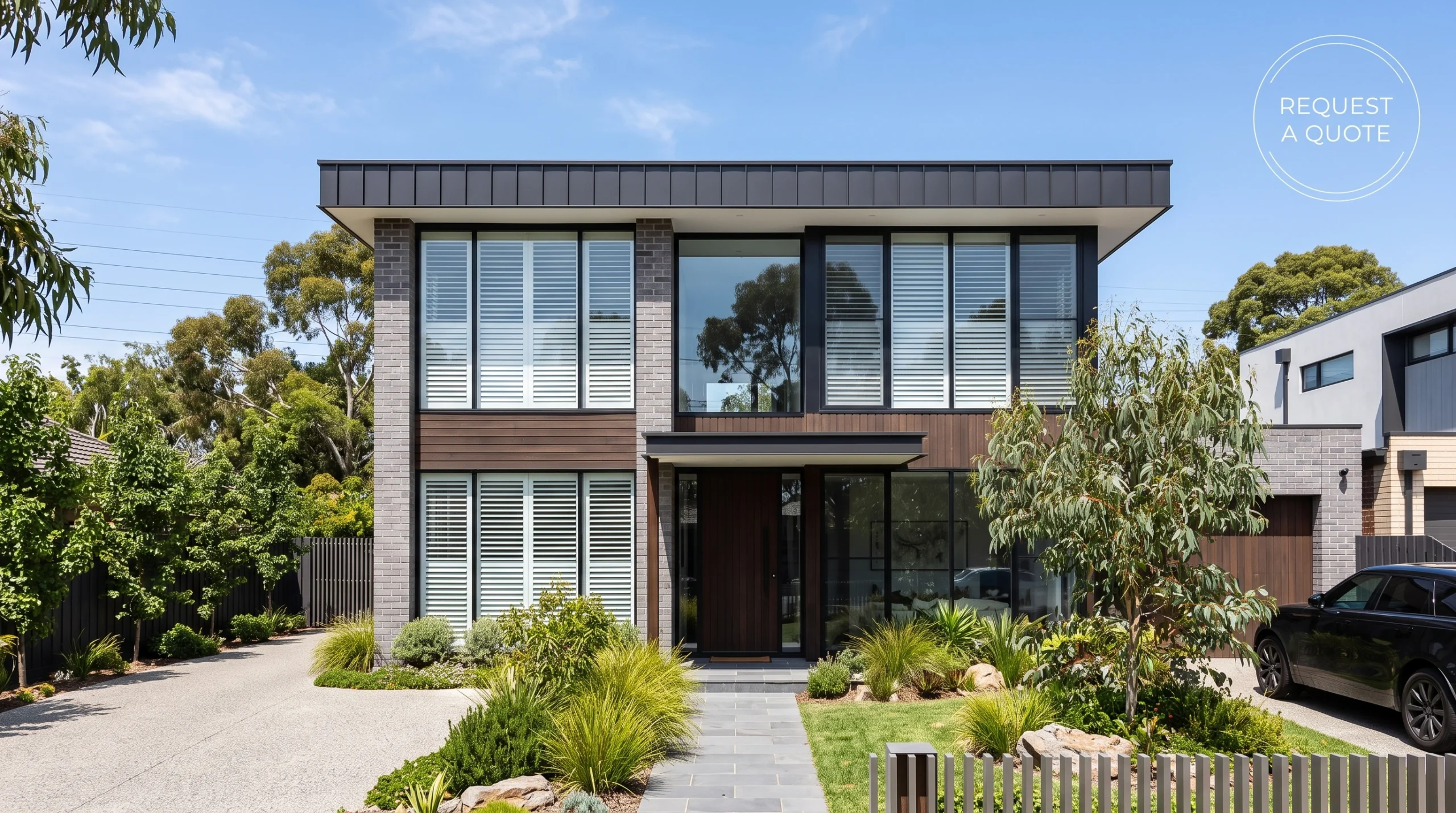 A beautiful modern Melbourne home exterior featuring large front windows fitted with crisp white plantation shutters visible from the outside.