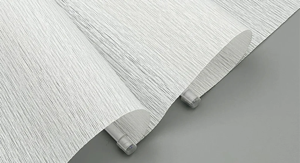Roman Blinds in Melbourne: The Complete Guide 4 A classic white Roman blind showing the neat folded pleat detail stacked at the top of a window in a minimalist interior.