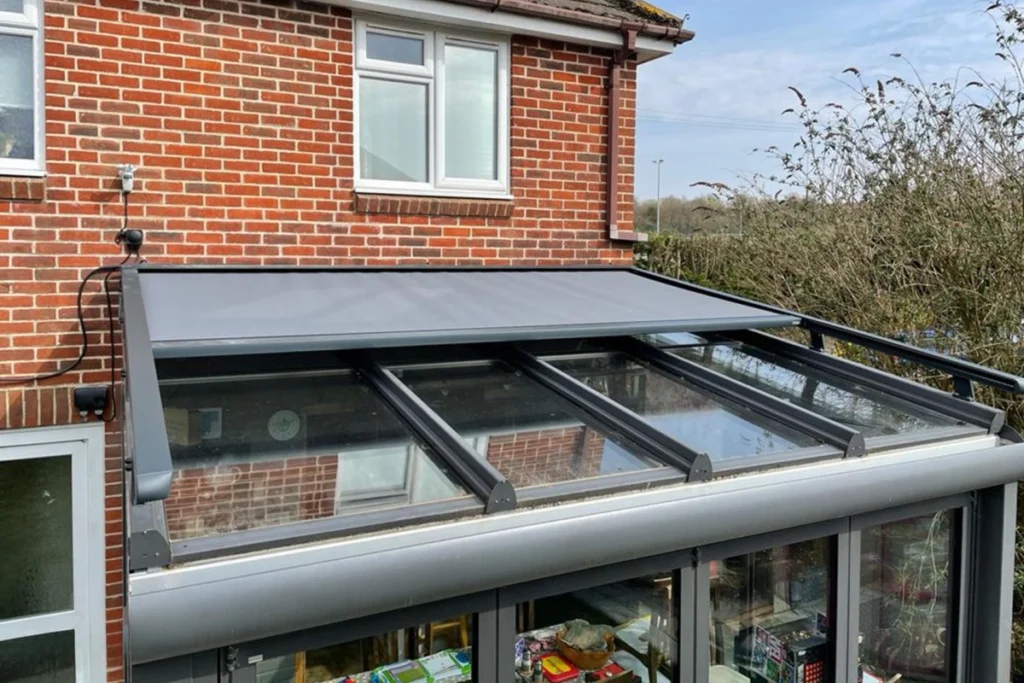 Crystal clear PVC outdoor café blinds enclosing a Melbourne patio space to protect against rain while maintaining an unobstructed garden view.