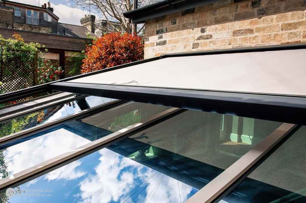 Outdoor mesh blinds lowered on a west-facing Melbourne pergola to block harsh afternoon sun glare and solar heat gain.
