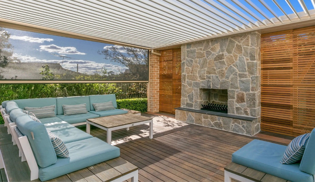 Ziptrak outdoor blinds enclosing a Melbourne alfresco entertaining area with outdoor furniture and greenery visible through the mesh.